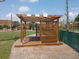 pergola  in legno di abete lamellare con pavimento galleggiante e vela in pvc e grigliati lineari